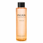 Inuka tissue oil bottle with orange liquid on a white background